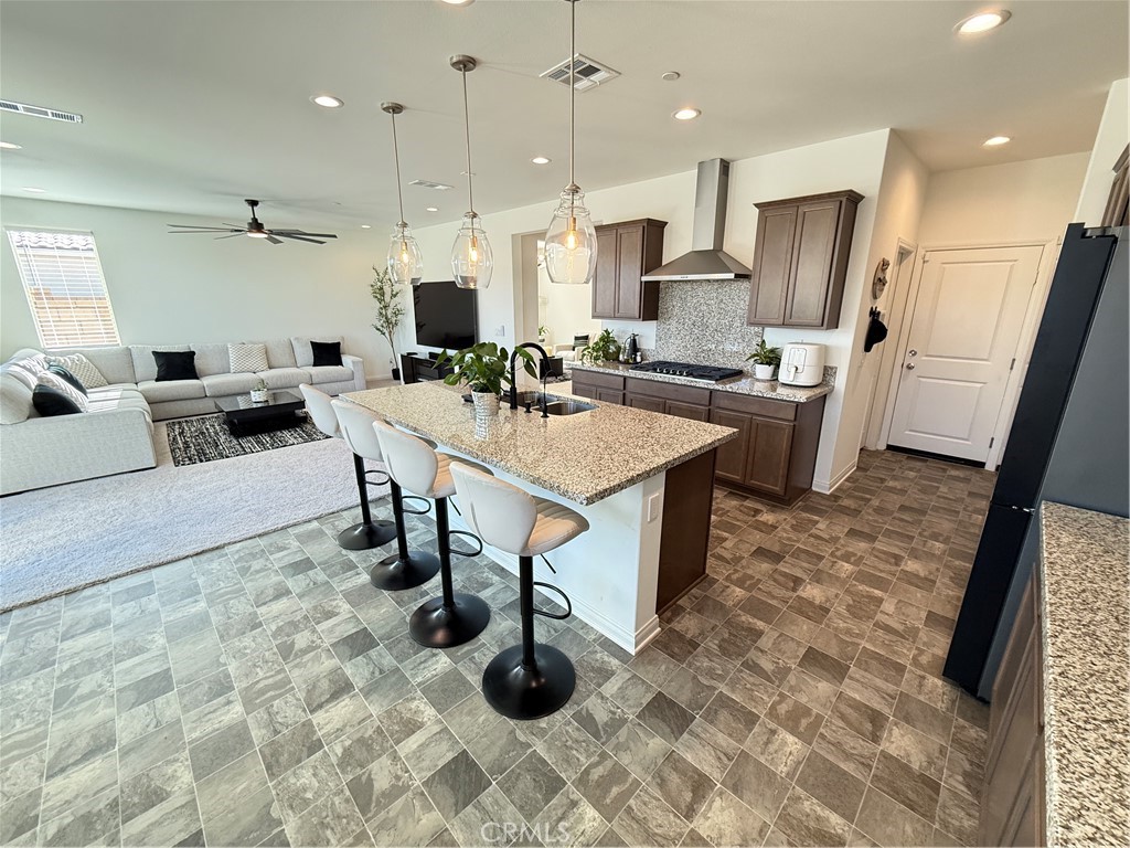 4461 Hickory Court Perris, CA 92571 - Photo 9 of 31 a large white kitchen with a table and chairs