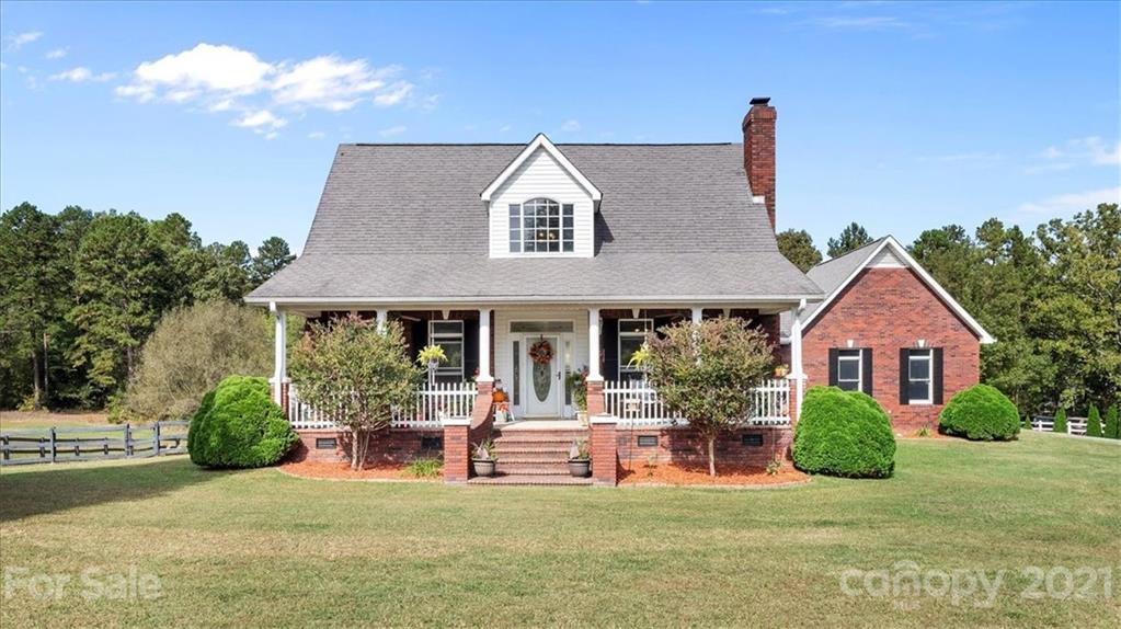 a view of a house with a backyard porch and sitting area