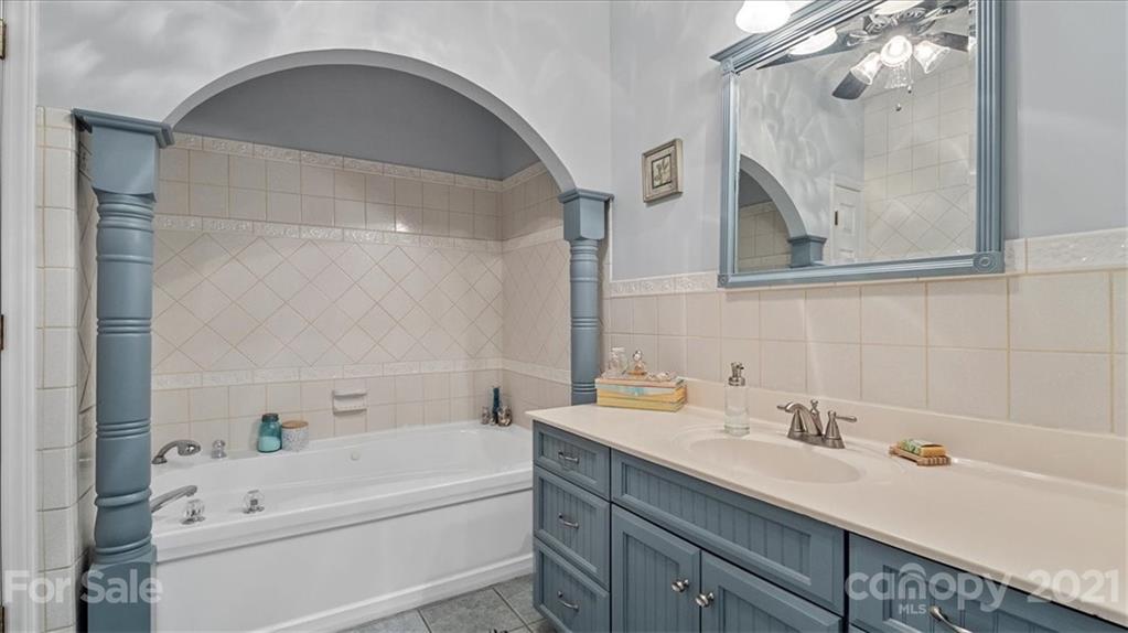 3928 Biggers Road Clover, SC 29710 - Photo 16 of 45 a bathroom with a tub sink and mirror