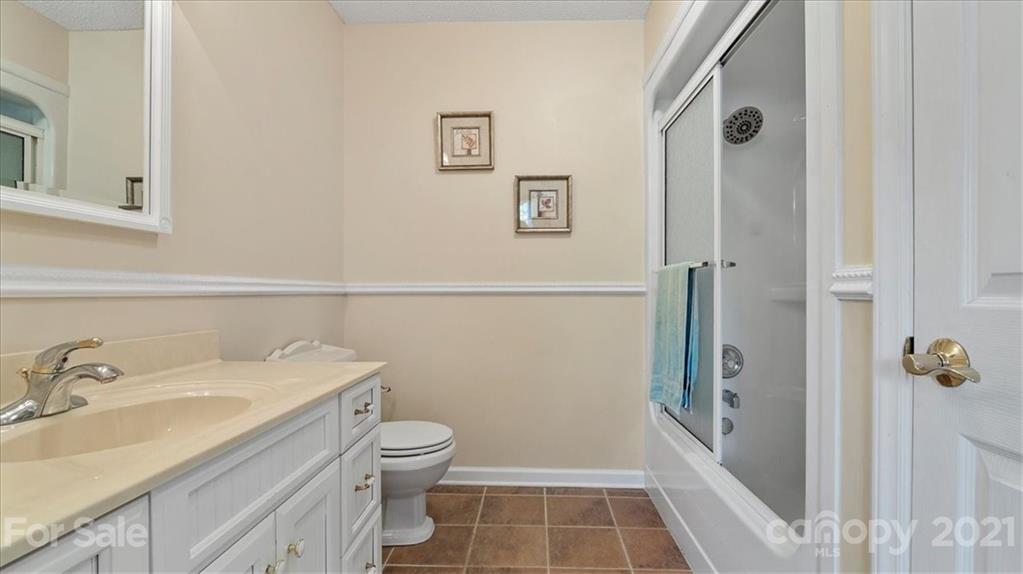 3928 Biggers Road Clover, SC 29710 - Photo 20 of 45 a bathroom with a sink a toilet a shower and a mirror
