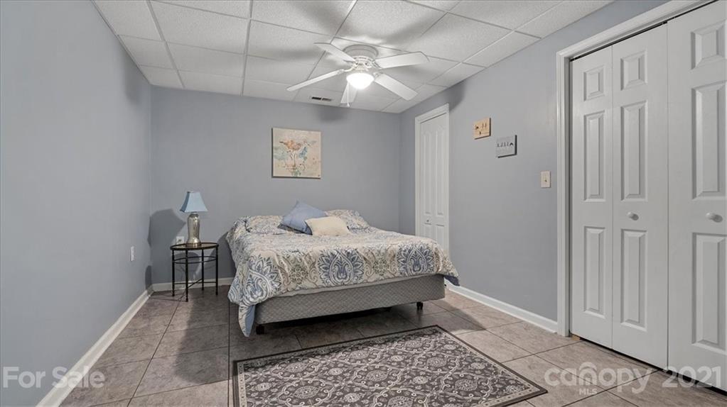 3928 Biggers Road Clover, SC 29710 - Photo 26 of 45 a bedroom with a bed and a chandelier