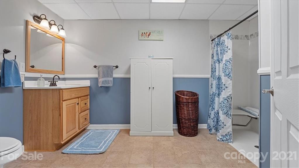 3928 Biggers Road Clover, SC 29710 - Photo 27 of 45 a bathroom with a granite countertop sink a toilet and a mirror