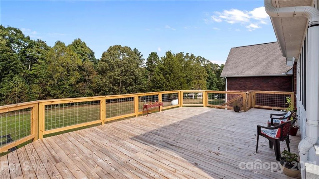 3928 Biggers Road Clover, SC 29710 - Photo 32 of 45 a view of a balcony with two chairs and wooden floor