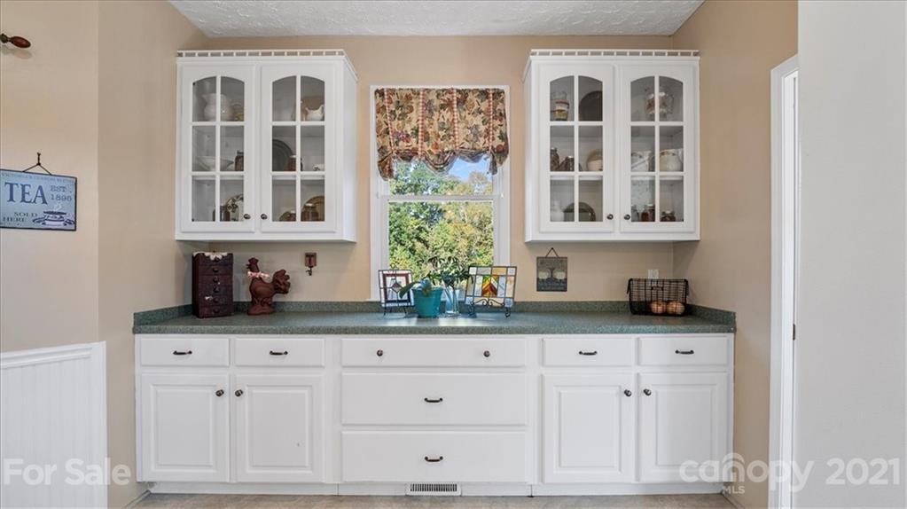 3928 Biggers Road Clover, SC 29710 - Photo 10 of 45 a kitchen with stainless steel appliances granite countertop white cabinets and window
