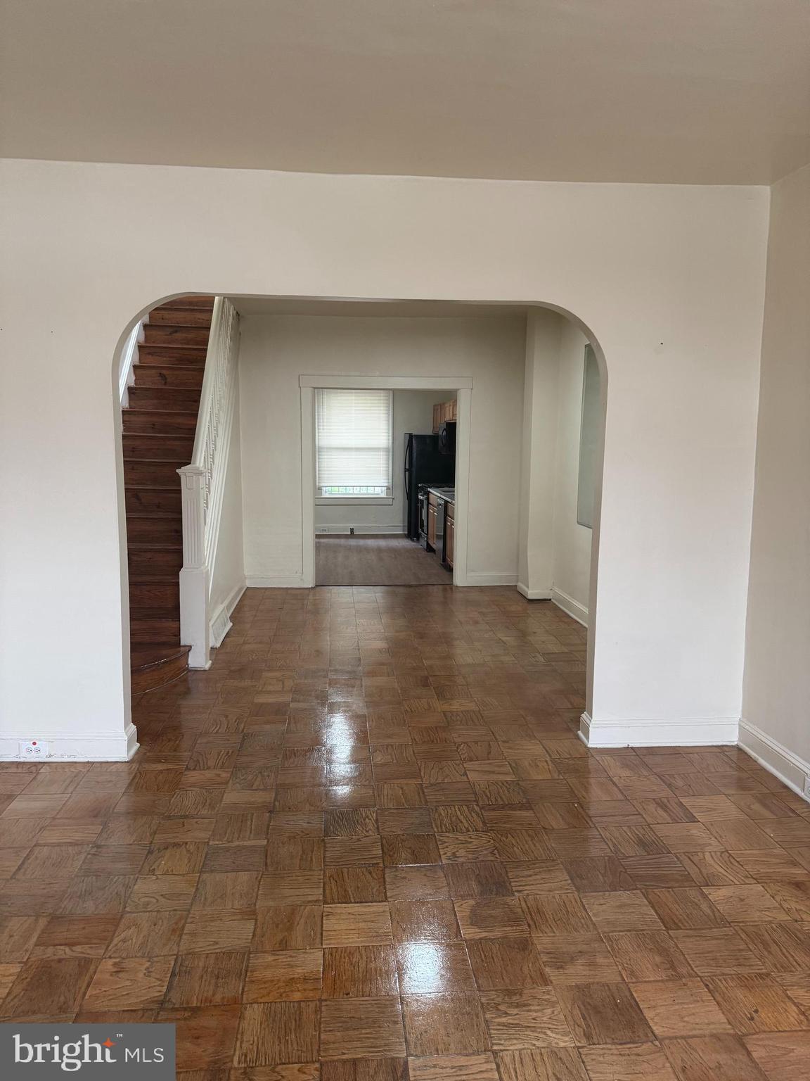 1638 Darley Avenue Baltimore, MD 21213 - Photo 3 of 15 a view of a hallway with wooden floor and chandelier