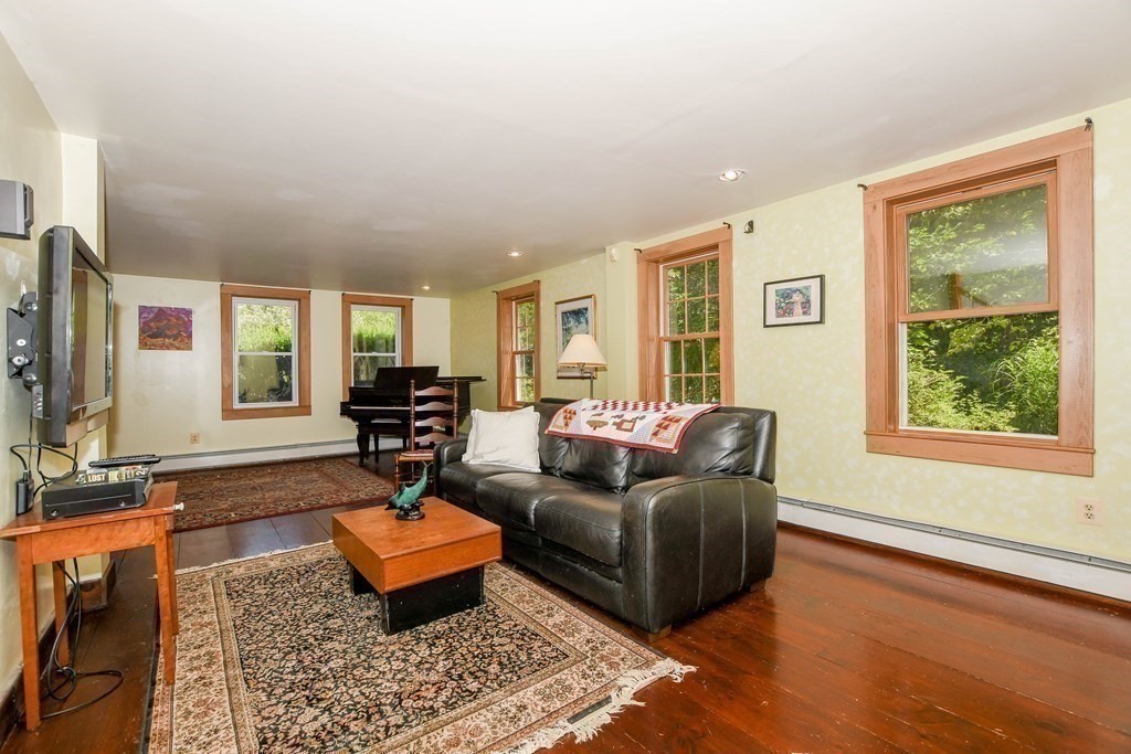 56 Marion Road Rochester, MA 02770 - Photo 11 of 39 a living room with furniture and a flat screen tv