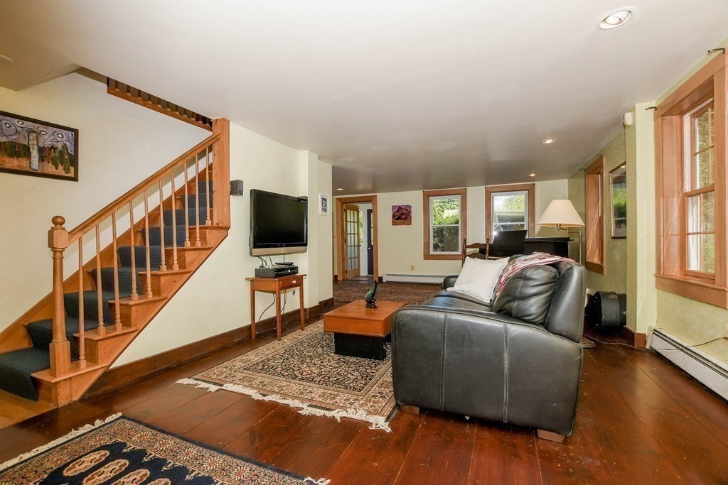 56 Marion Road Rochester, MA 02770 - Photo 14 of 39 a living room with furniture flat screen tv and a couch