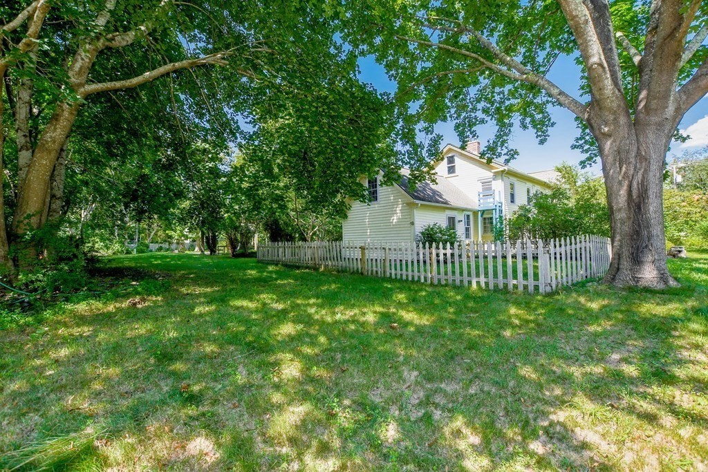 56 Marion Road Rochester, MA 02770 - Photo 28 of 39 a view of a house with a small yard and a large tree