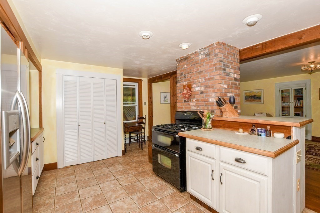 56 Marion Road Rochester, MA 02770 - Photo 7 of 39 a kitchen that has a stove and a table in it