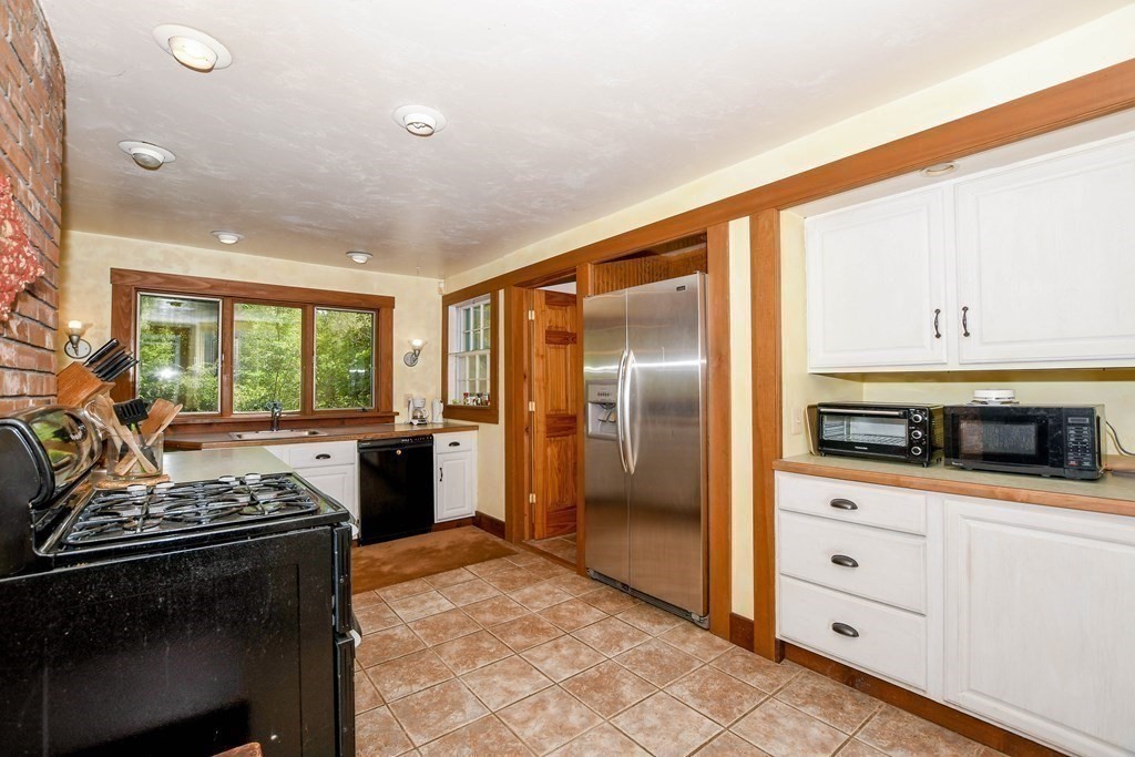 56 Marion Road Rochester, MA 02770 - Photo 9 of 39 a kitchen with stainless steel appliances a stove a sink and a refrigerator