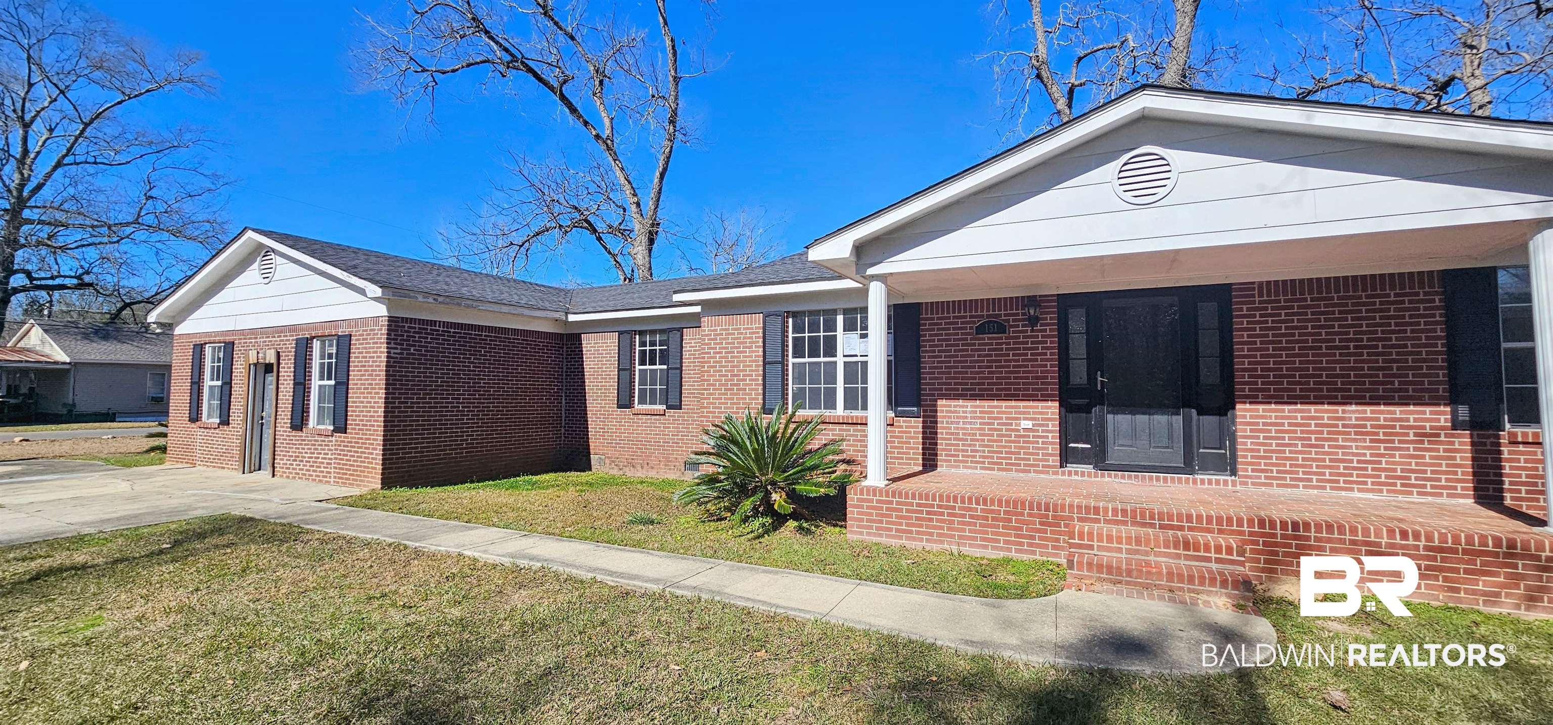 151 Bullard Street Atmore, AL 36502 - Photo 4 of 38 Ranch-style home with a porch, a front yard, and brick siding