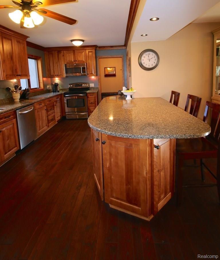 3770 Clyde Road Holly, MI 48442 - Photo 7 of 34 Hickory plank flooring, quartz counters and stainless appliances.
