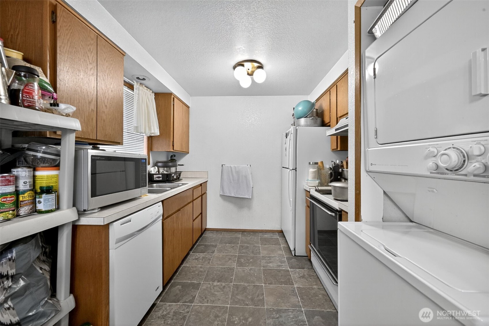 410 10th Street Lynden, WA 98264 - Photo 17 of 28 a kitchen with a sink cabinets and stainless steel appliances