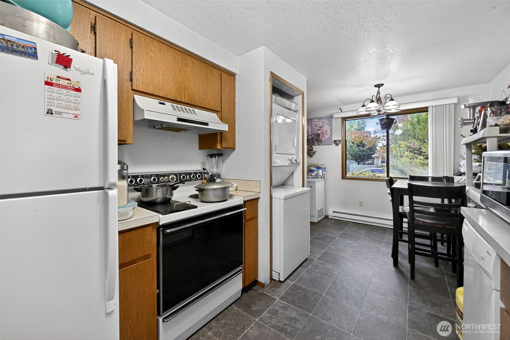 410 10th Street Lynden, WA 98264 - Photo 7 of 28 a kitchen with a stove and a refrigerator