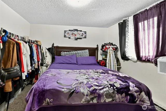 a bed sitting in a bedroom next to a window