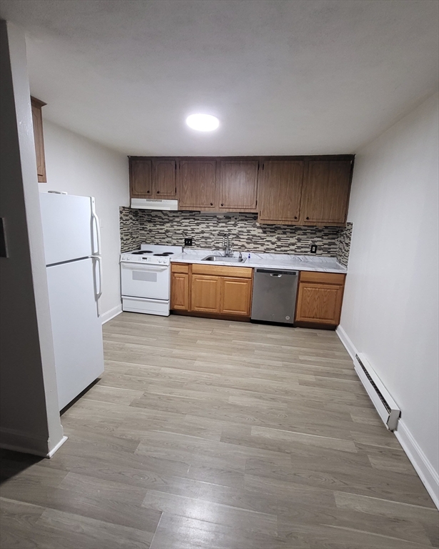 1 Walker Road, Unit 1 North Andover, MA 01845 - Photo 2 of 8 a large kitchen with kitchen island a stove a refrigerator sink and white cabinets
