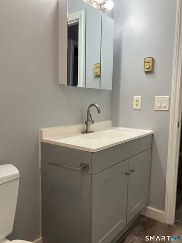 a view of a room with wooden floor and doors