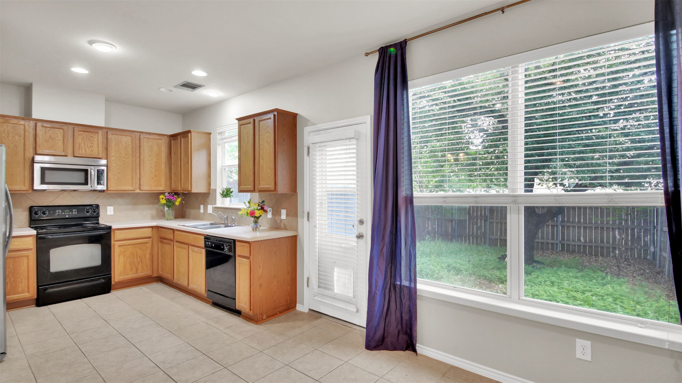 73 Verde Ranch Loop Leander, TX 78641 - Photo 11 of 29 a kitchen with stainless steel appliances granite countertop a stove and a sink