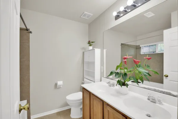 a bathroom with a sink vanity granite and a toilet