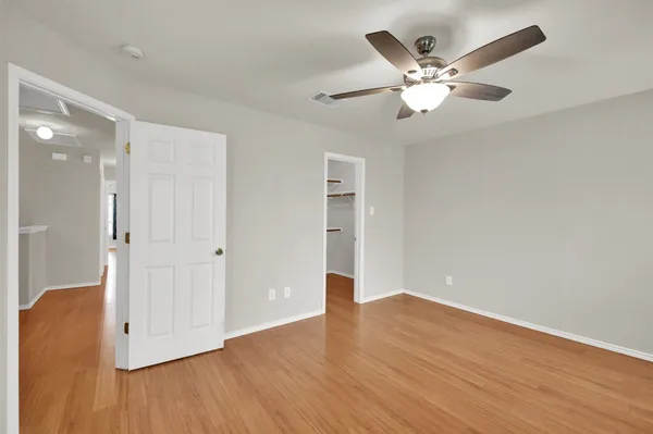 a view of an empty room with wooden floor