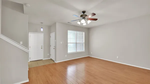 wooden floor in an empty room with a window