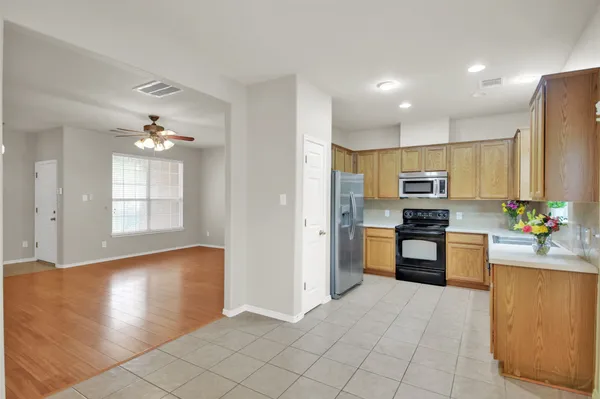 a kitchen with stainless steel appliances granite countertop a refrigerator and a sink