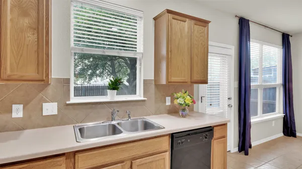 a kitchen with stainless steel appliances a sink and a window