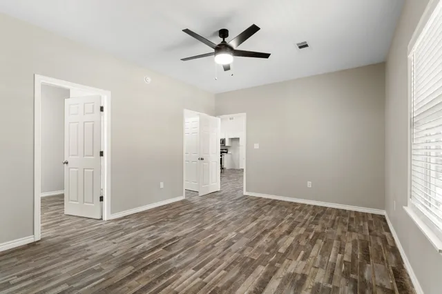 wooden floor in an empty room with a window