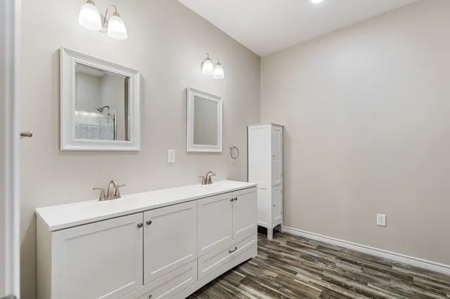 a bathroom with a double vanity sink and mirror
