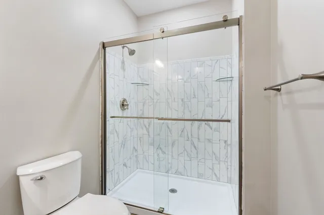 a bathroom with a glass shower door