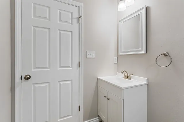 a bathroom with a sink and vanity