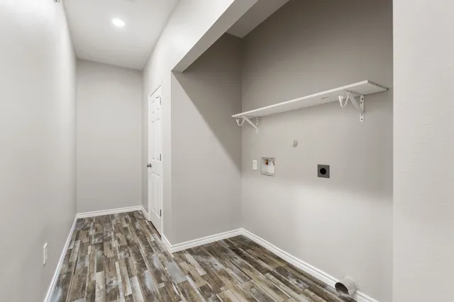 a view of a room with wooden floor