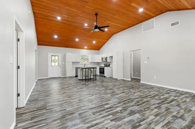 a view of a room with wooden floor