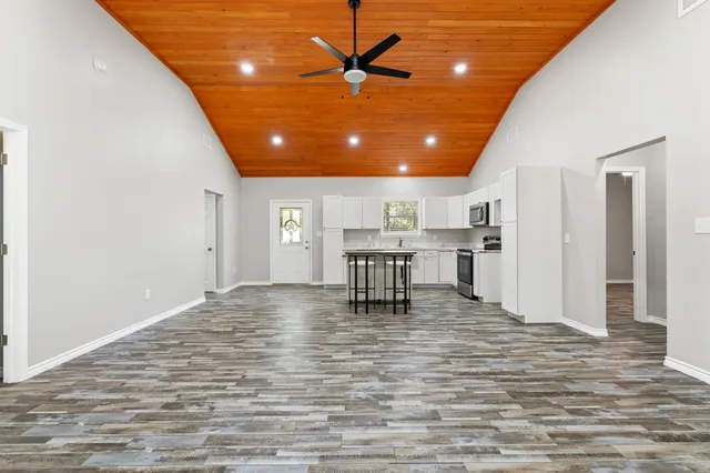 a view of a kitchen with a dining table and chairs