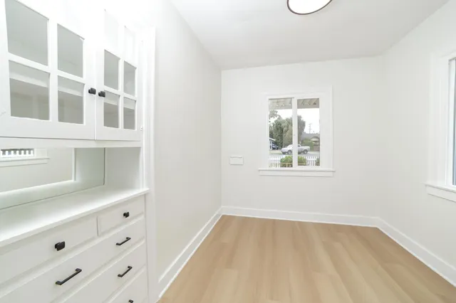 a view of an empty room with a window and closet