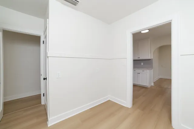 a view of a room with wooden floor