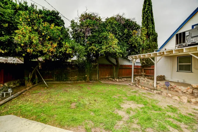 a backyard with a table and chairs