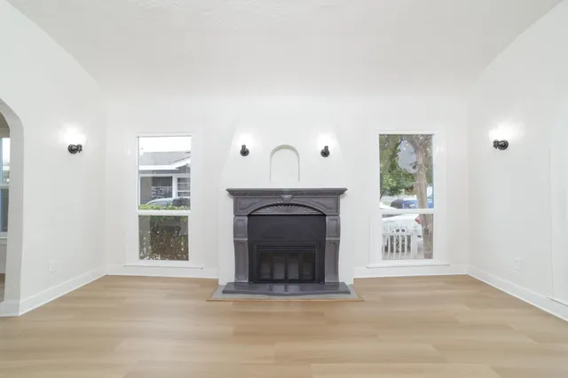 a view of a livingroom with a fireplace and window