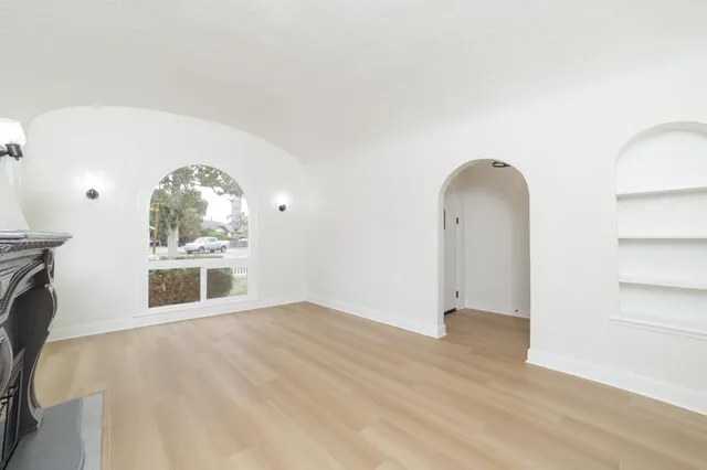 wooden floor in an empty room with a window