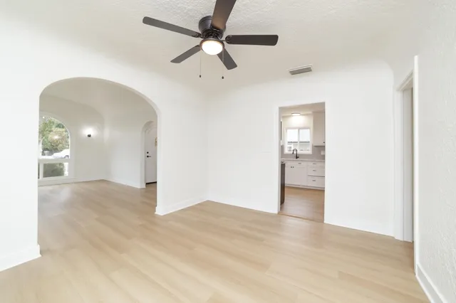 a view of a livingroom with a ceiling fan and wooden floor