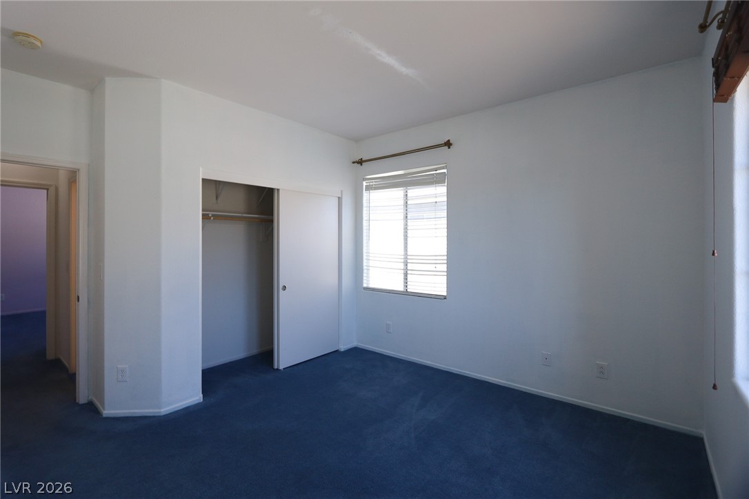 6472 Centennial Road Pahrump, NV 89048 - Photo 13 of 29 Well-lit room with ample space, featuring soft carpeting and a window for natural light.