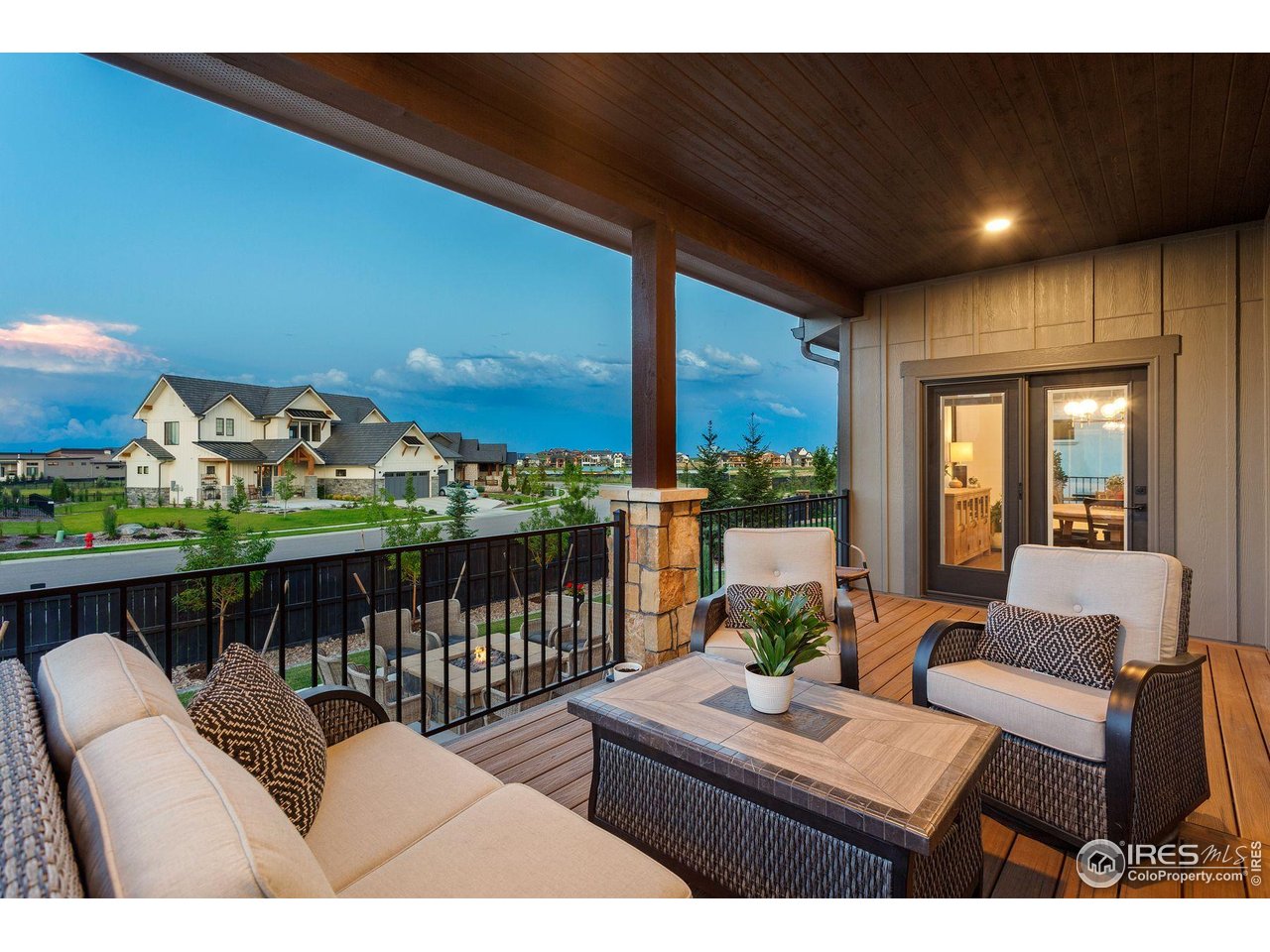 2734 Southwind Road Berthoud, CO 80513 - Photo 16 of 50 Covered Back Deck Overlooking the Gas Firepit & Backyard