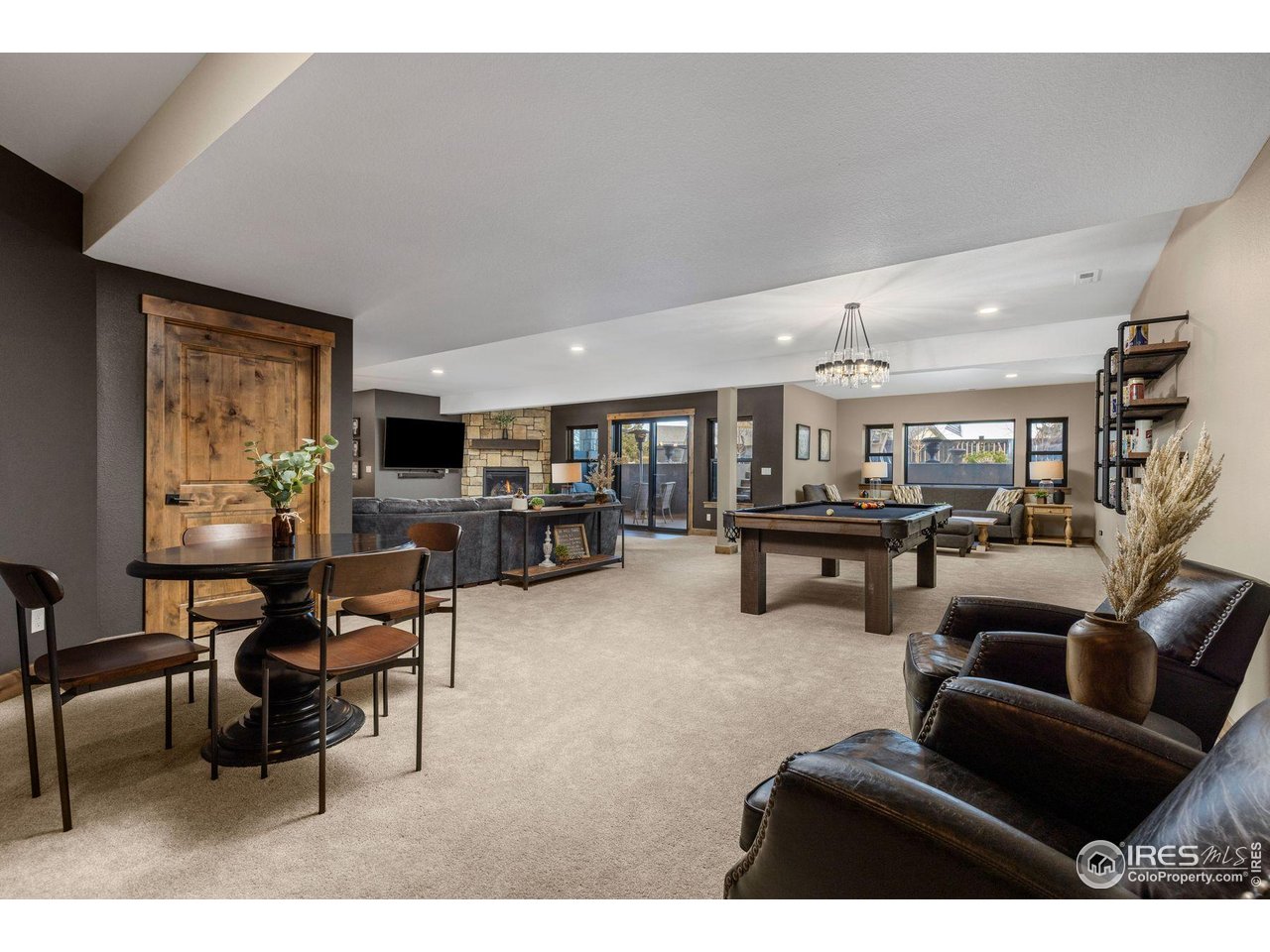 2734 Southwind Road Berthoud, CO 80513 - Photo 39 of 50 Expansive Walkout Basement with Wet Bar, Fireplace, and Covered Patio area Leading to Gas Firepit