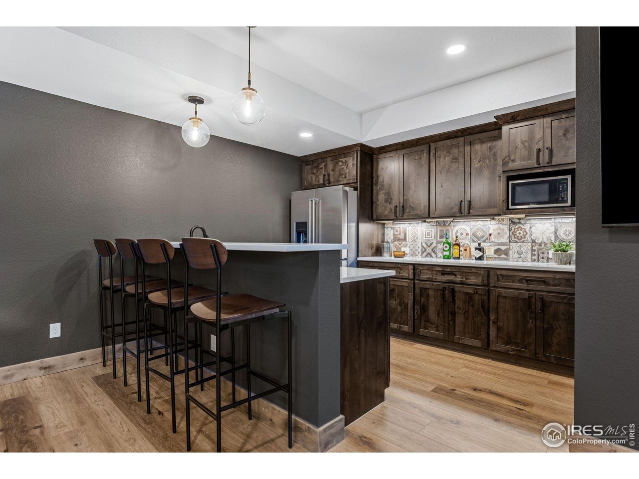 2734 Southwind Road Berthoud, CO 80513 - Photo 41 of 50 Custom Bar is Equipped with Full-Sized Refrigerator, Dishwasher, and Microwave