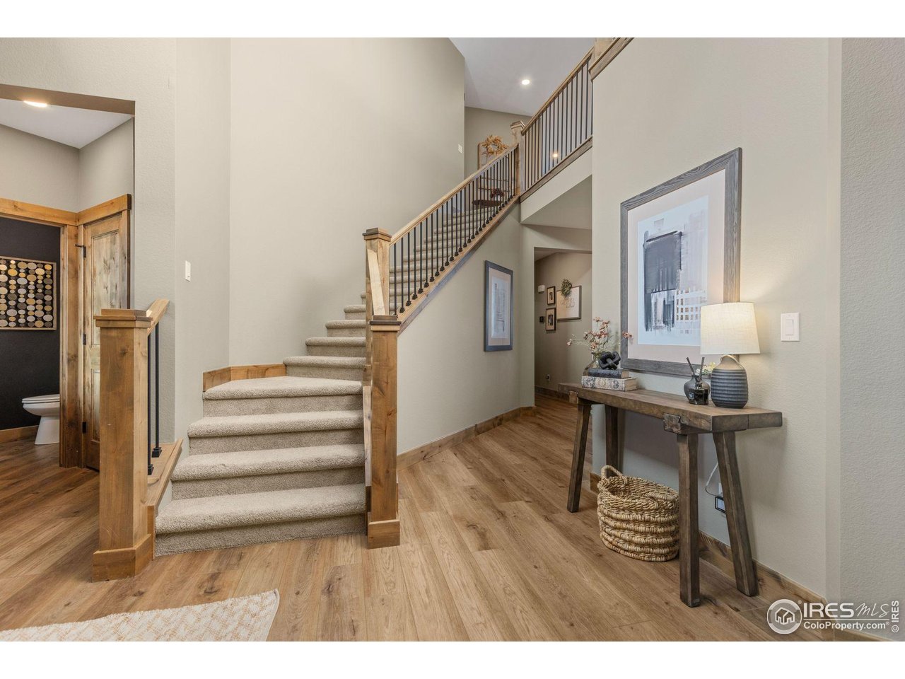 2734 Southwind Road Berthoud, CO 80513 - Photo 6 of 50 Grand Staircase to Upper Level and Hallway to Great Room