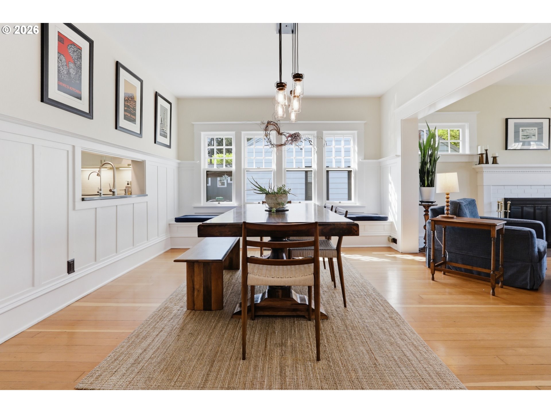 3326 Northeast 60th Avenue Portland, OR 97213 - Photo 11 of 46 a dining room with wooden floor a chandelier a wooden table and chairs