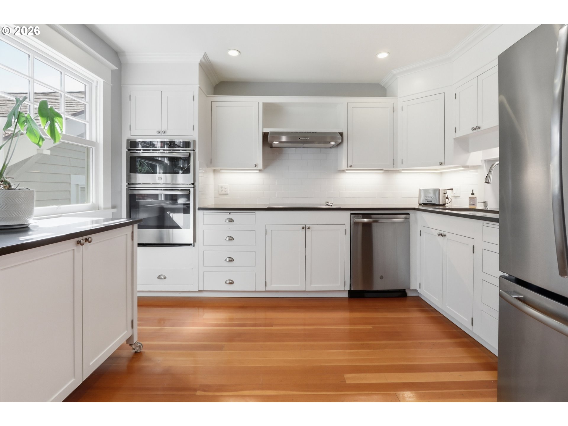 3326 Northeast 60th Avenue Portland, OR 97213 - Photo 14 of 46 a kitchen with stainless steel appliances granite countertop a stove a sink and a refrigerator