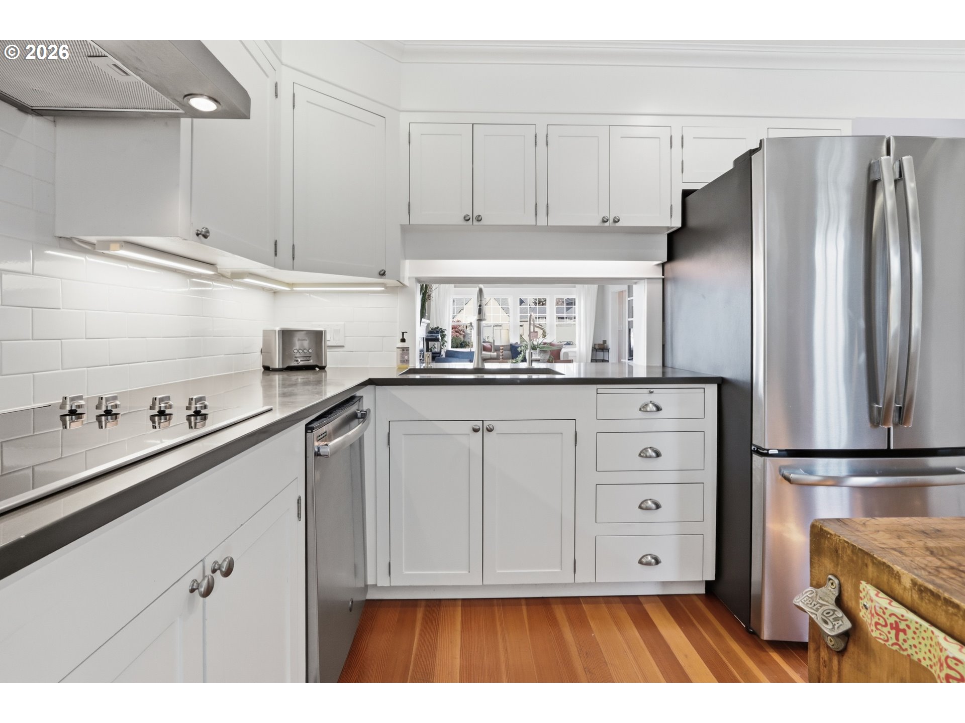 3326 Northeast 60th Avenue Portland, OR 97213 - Photo 15 of 46 a kitchen with white cabinets and stainless steel appliances