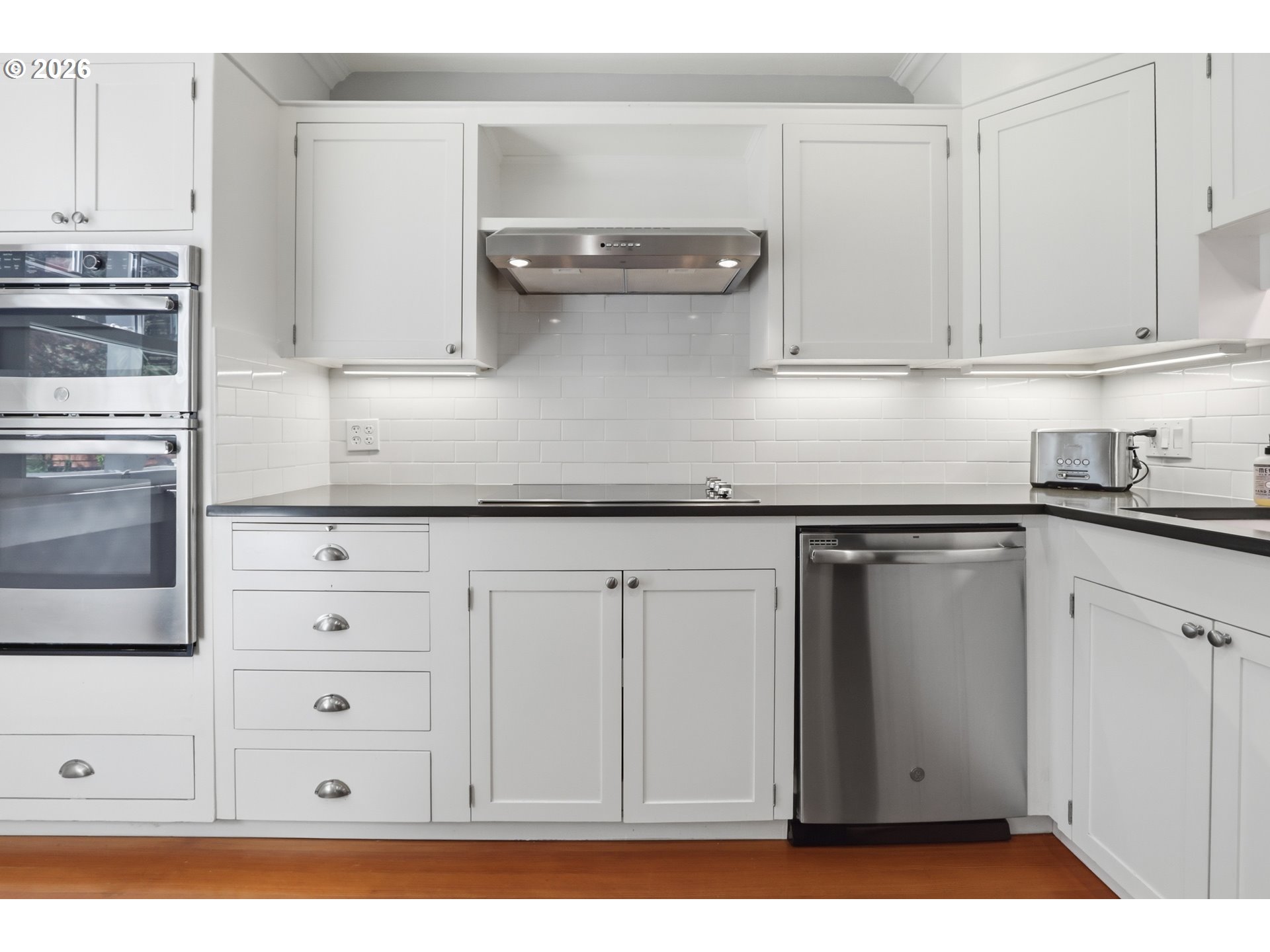 3326 Northeast 60th Avenue Portland, OR 97213 - Photo 16 of 46 a kitchen with granite countertop white cabinets and stainless steel appliances