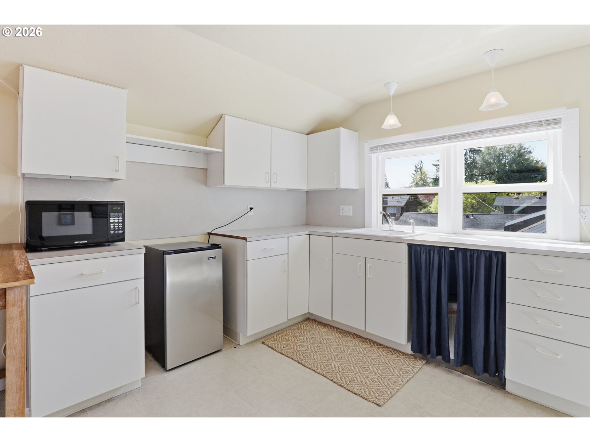 3326 Northeast 60th Avenue Portland, OR 97213 - Photo 25 of 46 a kitchen with a sink a stove and cabinets